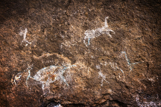 A group of hunters and animals, rupestrian rock art in Sumbay Cave from paleolithic era (6000-8000 BC), Arequipa departement, Southern Peru