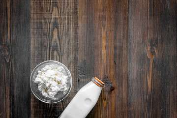 Non GMO, prservatives-free organic food. Milk, cottage on dark wooden background top view copyspace