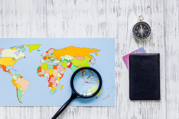 Planning trip. World map, bank card and compass on wooden table background top view copyspace