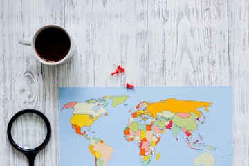 Planning trip. World map on wooden table background top view copyspace