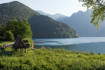 Ledro lake, prehistoric stilt house (reconstruction), Trentino  - UNESCO World Heritage Site
 - obrazy, fototapety, plakaty