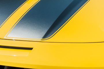 Close up of hood of a yellow sport car