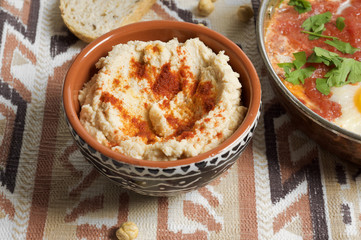 Tomato and red pepper shakshouka with hummus and wholemeal bread