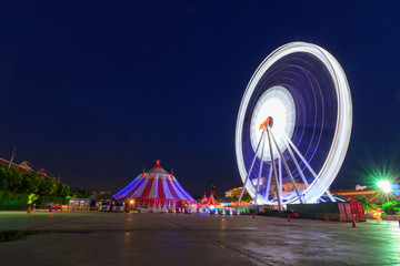 Blur light of Ferris wheel in night time