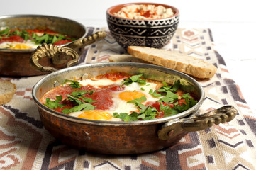 Tomato and red pepper shakshouka with hummus and wholemeal bread