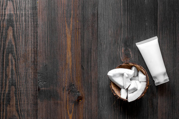 Skin care. Coconut cream on wooden table background top view copyspace
