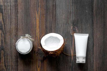 Skin care. Coconut oil and cream on wooden table background top view copyspace