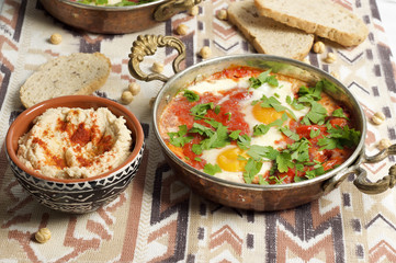 Tomato and red pepper shakshouka with hummus and wholemeal bread