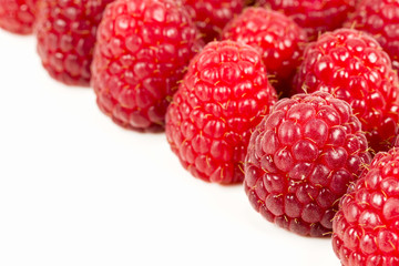 fresh red raspberries isolated on white background