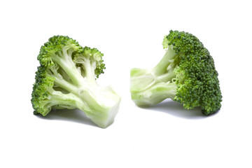Two pieces of green broccoli with shadow on white background