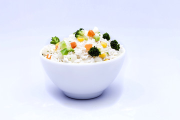 Bowl of rice with vegetables with shadow on white background
