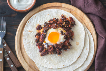 Tortilla with chipotle bean chili and baked egg
