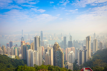 Obraz premium Beautiful view from Victoria Peak to the city of Hong Kong in the horizont in a sunny day with blue sky