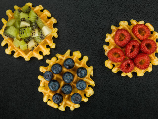 Belgian Butter Waffles With Blueberries Raspberries and Kiwi Fruit
