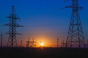 Fototapeta premium high-voltage power lines at sunset.