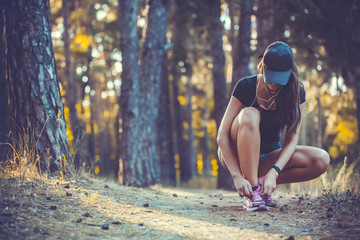 woman Runner tying shoelaces on sneakers.