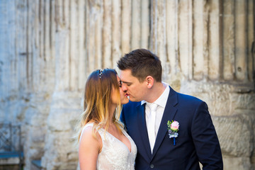 Bride and groom posing on the old streets of Rome, Italy