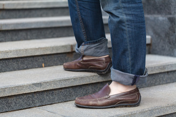 Walking upstairs: close-up view of man's leather shoes