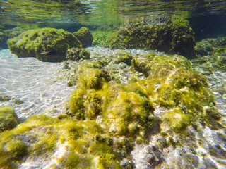 Rocks and sand seen from underwater