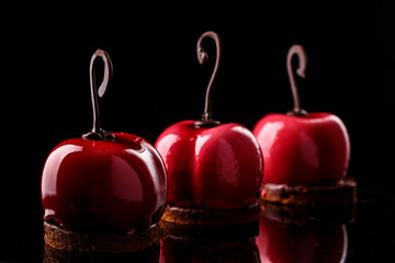 Glossy mousse cakes in the form of cherries