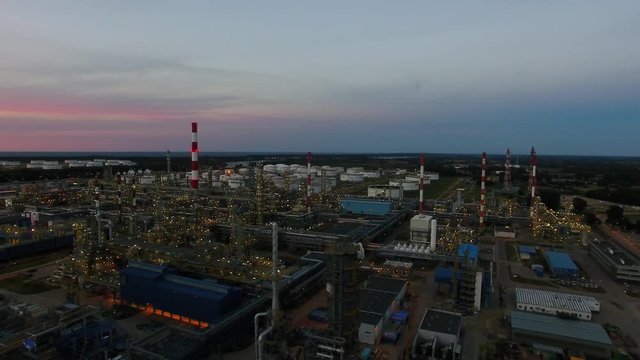Aerial view of the petrochemical oil refinery plant shines at night