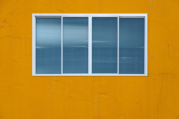 Modern glass window on the yellow wall,blanket window (frame)