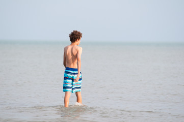 Fototapeta na wymiar Thirteen year old boy in the water of Lake Erie