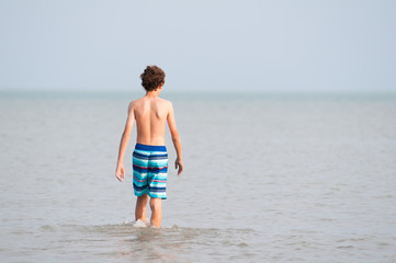 Thirteen year old boy in the water of Lake Erie