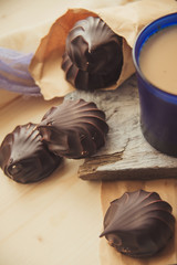 A cup of cafe latte with coffee beans and cookies