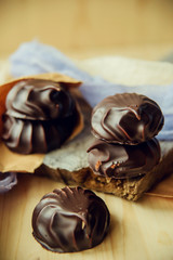 small chocolate-covered cream cake