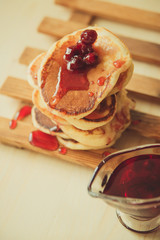 Stack of pancakes with jam and sugar