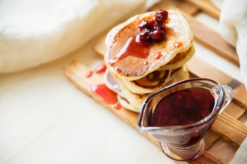 Stack of pancakes with jam and sugar
