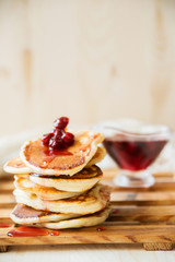 Stack of pancakes with jam and sugar