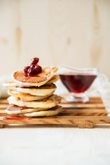 Stack of pancakes with jam and sugar
