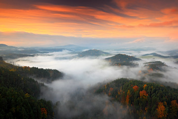 Hills and villages with foggy morning. Morning fall valley of Bohemian Switzerland park. Hills with fog, landscape of Czech Republic, landscape from Ceske Svycarsko. Czech typical autumn landscape.