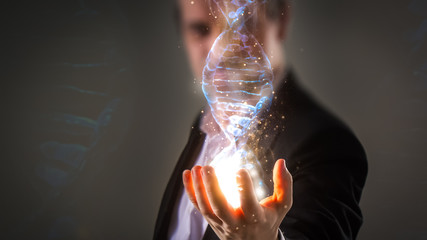 close up of Businessman holding glowing DNA helix with energy sparks