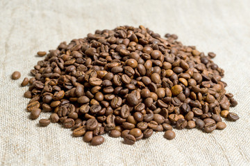 Spilled grains of fragrant coffee close-up.