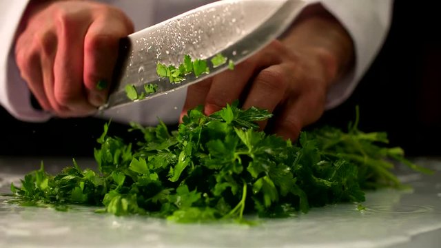 chopping fresh parsley. slow motion