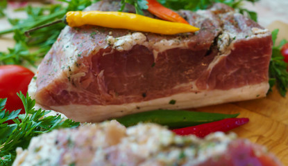 Piece of pork salted in the traditional way, along with chili.
