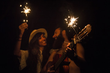 Friends playing with sparkles at the night