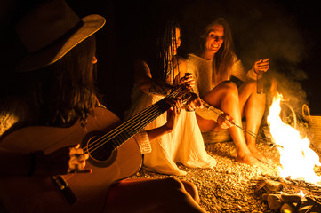 Friends Gathered Around a Campfire © karrastock