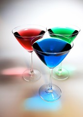 3 glasses woth colored liquid