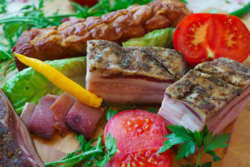 Salted traditional way of pieces of pork, along with chili and vegetables.