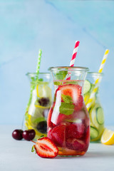 Refreshing summer homemade cocktail in glass bottles. Detox fresh water. Selective focus. Copy space.