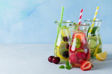 Refreshing summer homemade cocktail in glass bottles. Detox fresh water. Selective focus. Copy space.