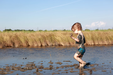 Child running in healing mud