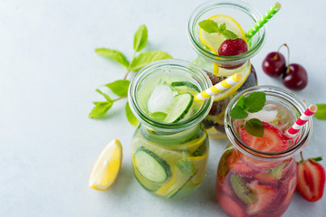 Refreshing summer homemade cocktail in glass bottles. Detox fresh water. Selective focus. Copy space.