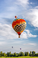 Colorful hot air balloons flying in the blue sky.  Balloon Festival — The Golden Ring Of Russia...