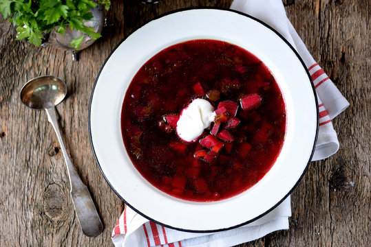 Traditional Ukrainian soup borsch on an old wooden background. Rustic style.