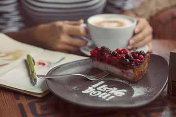 Young woman sitting indoor in urban cafe